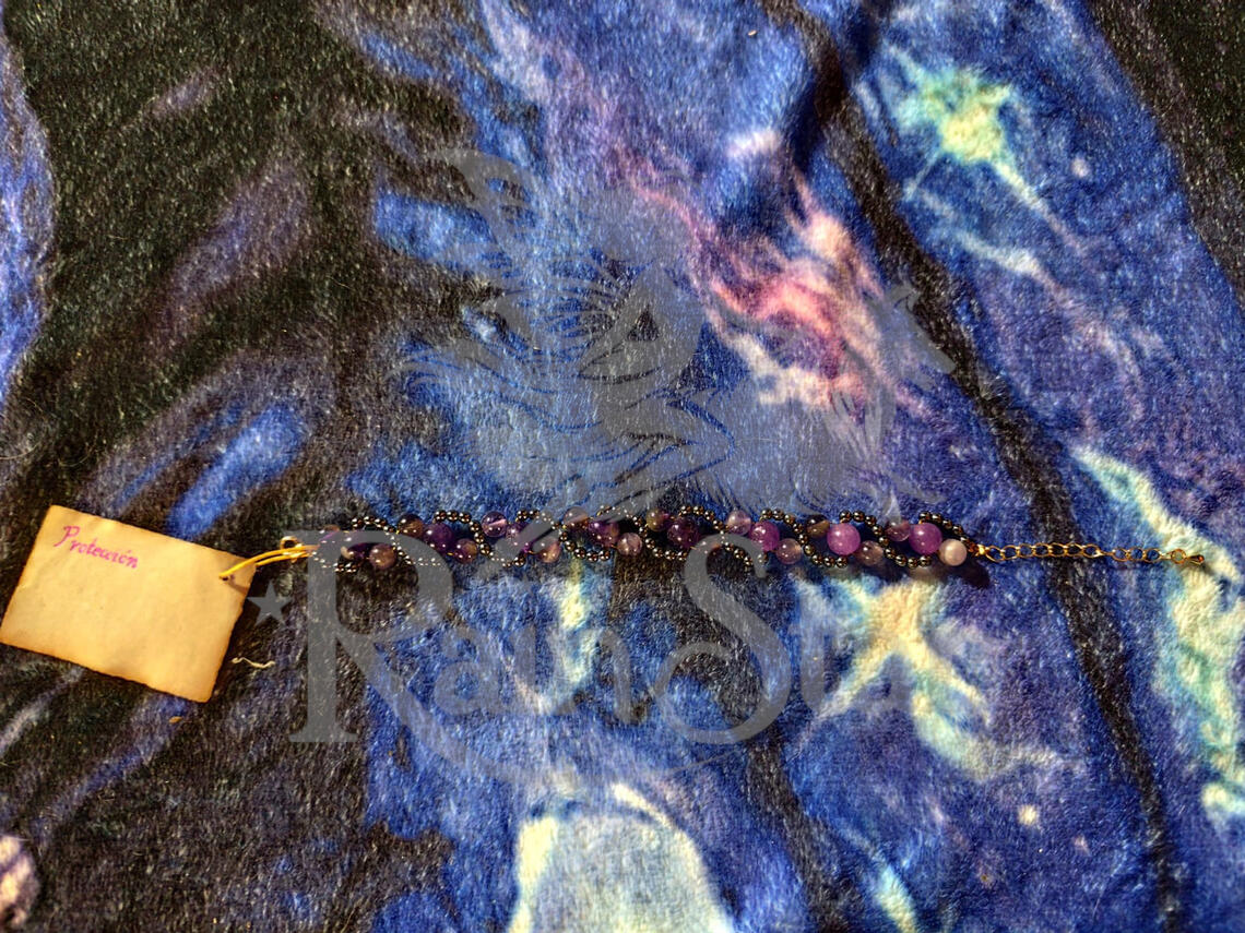 A beautiful handmade bracelet with a spiral design evocative of the gas giant planets. Featuring amethyst for psychic protection and intuition and hematite for grounding, this elegant piece is a must-have for any serious stone lover's collection.