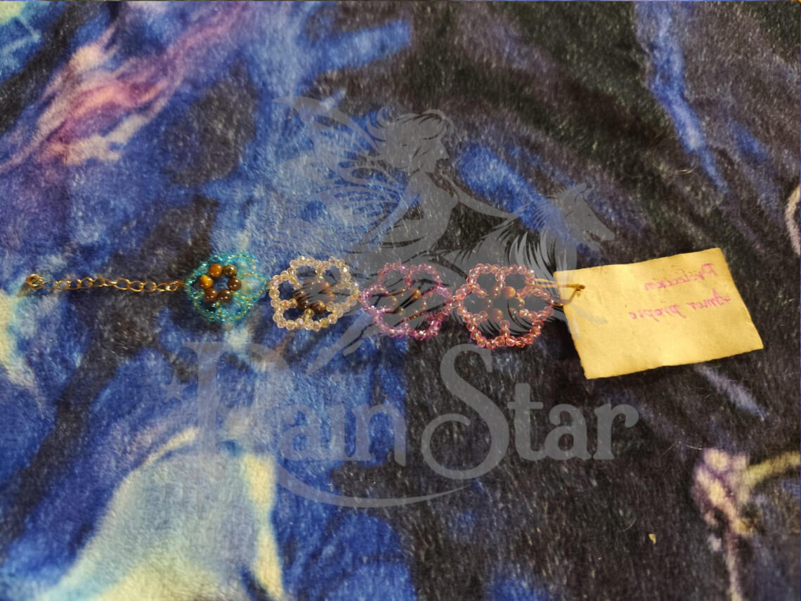 A beautiful floral bracelet, hand woven from jeweler's wire, featuring high-quality glass beads and tiger's eye to offer protection, boost confidence and self love.
