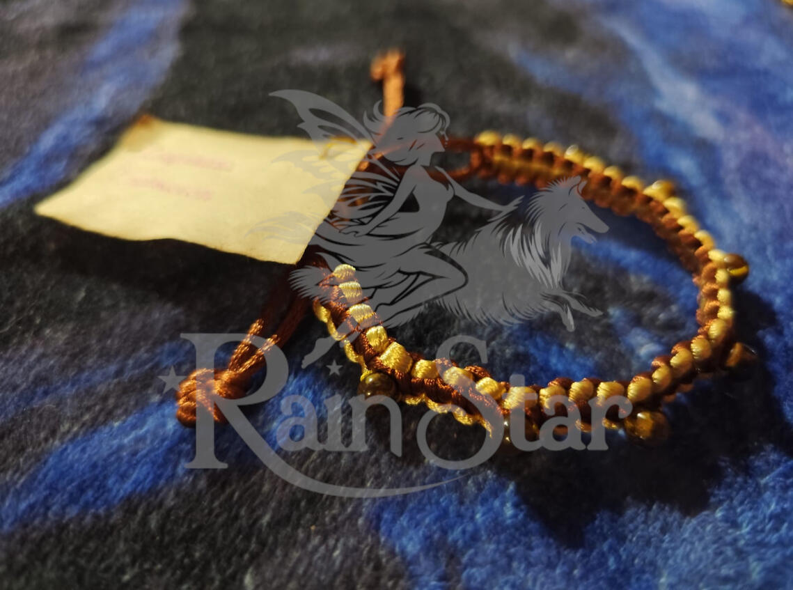 A handwoven adjustable bracelet featuring tiger's eye, created to support confidence and call in abundance.