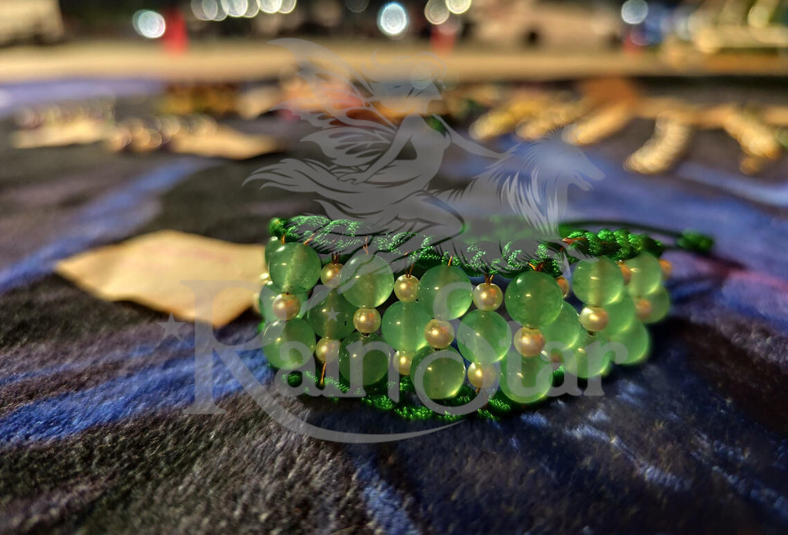 A handwoven adjustable bracelet featuring green aventurine and glass accents, created to support luck, growth, and opportunity.